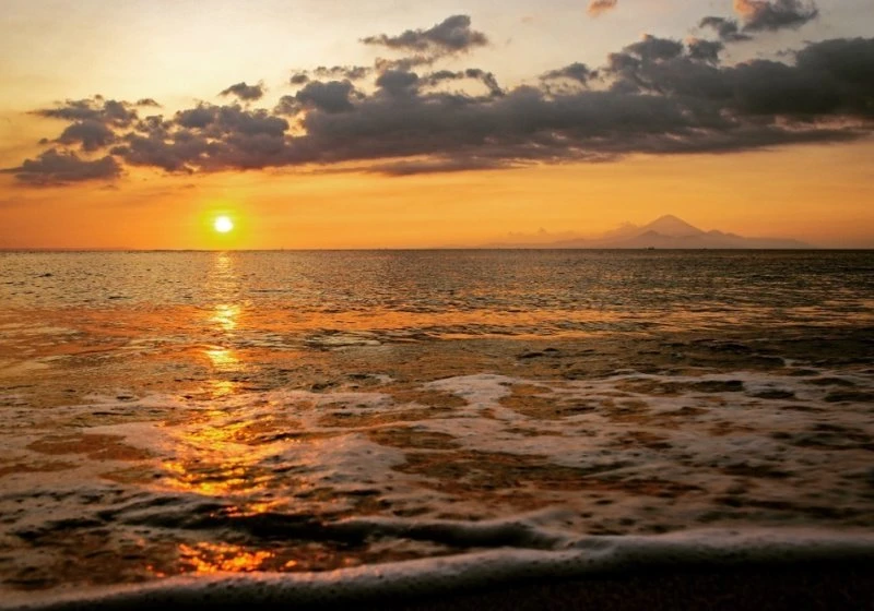 sun setting behind the Gili Islands