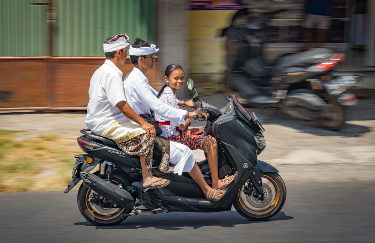 Riding a scooter on a quiet road, the everyday way of getting around when living in Lombok
