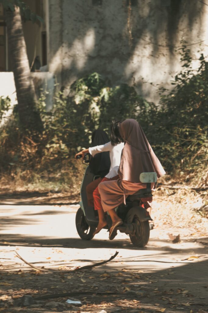 Riding a scooter in Lombok on a local street